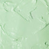Textura do produto de creme para mãos FPS 60 da Ollie de cor esverdeada.
